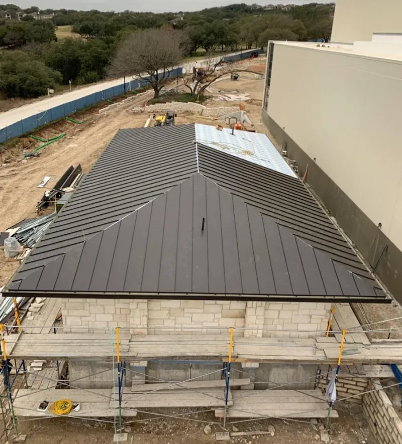 Metal roof new construction with scaffolding in Vernon